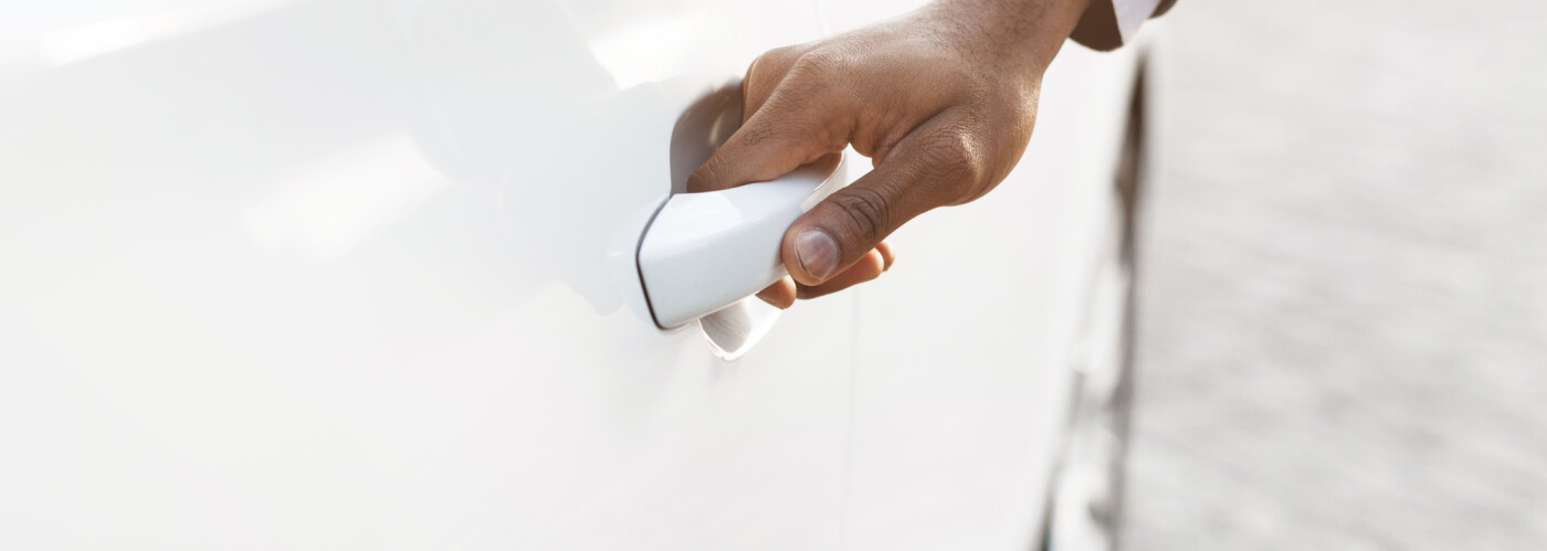 Man holding car door handle